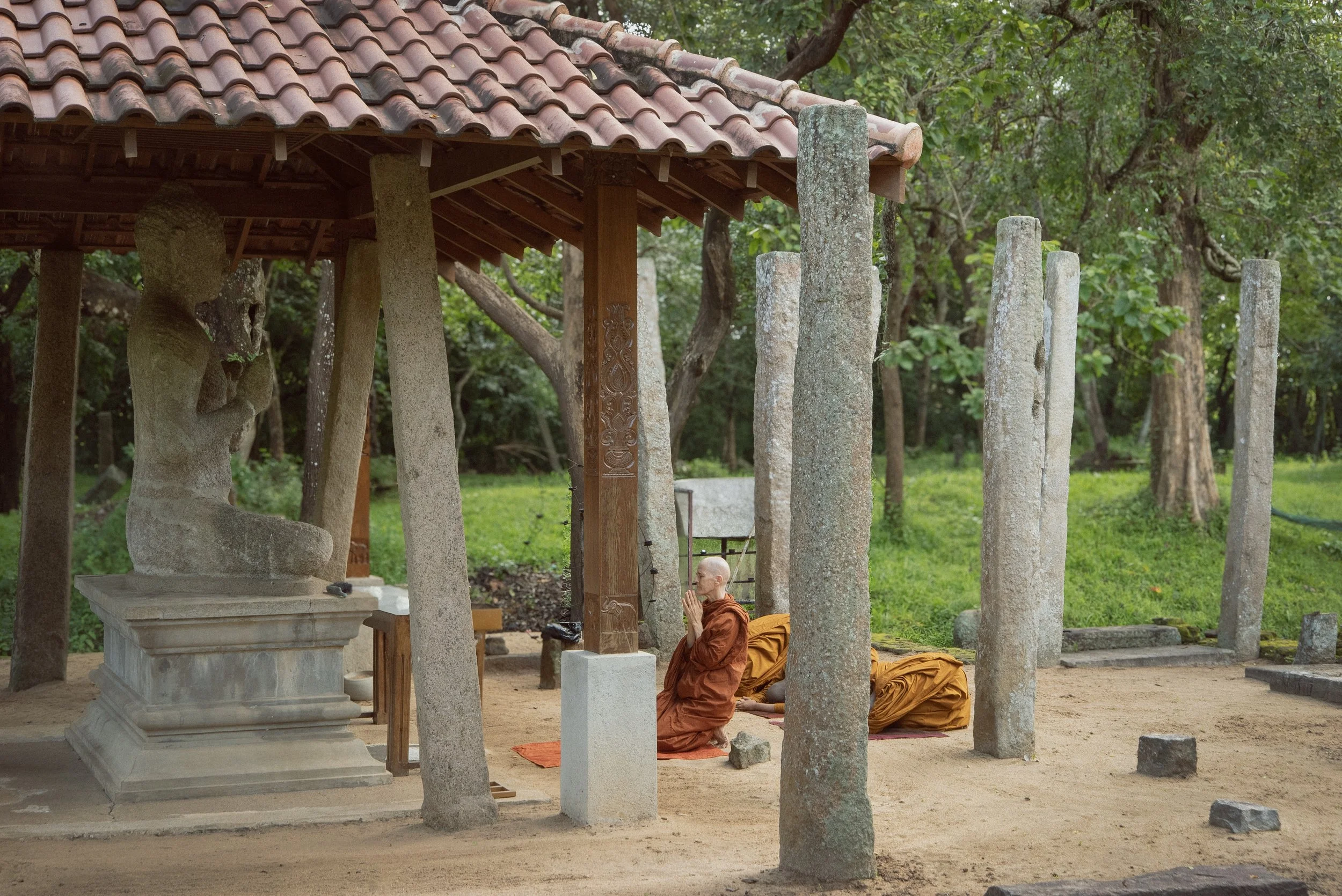 Ven. Saccadharani is bowing in front of the Buddha statue of the ancient Bikkhuni Monastery Pankuliaya Ashokaramaya in Anuradhapura