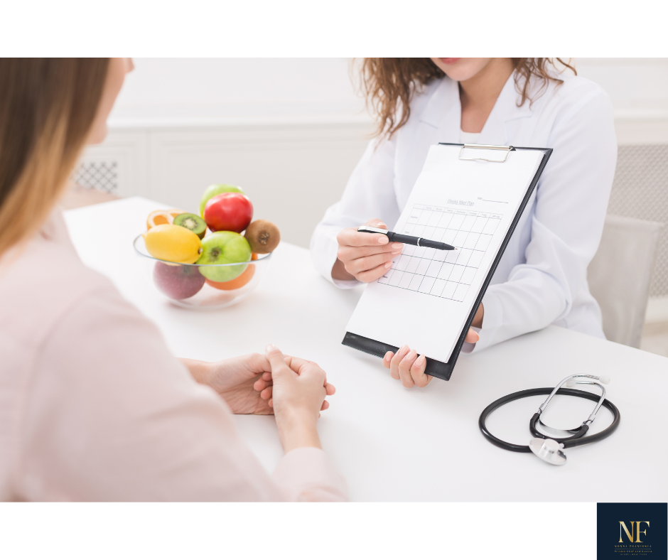 Medical consultation with a doctor and a patient, with a bowl of assorted fresh fruits on the table.