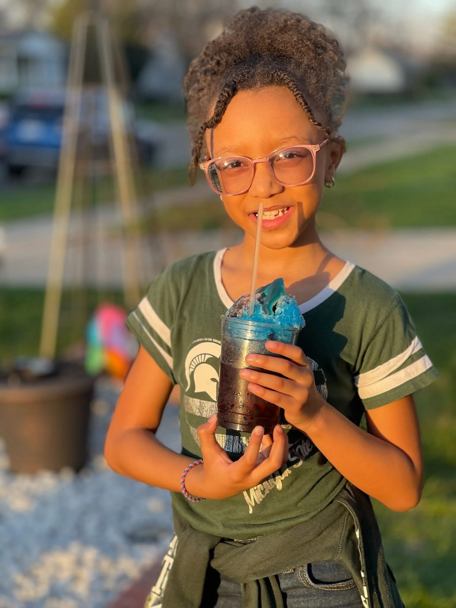 A young person enjoying a Sno Ball from Amaizeing Dawgs
