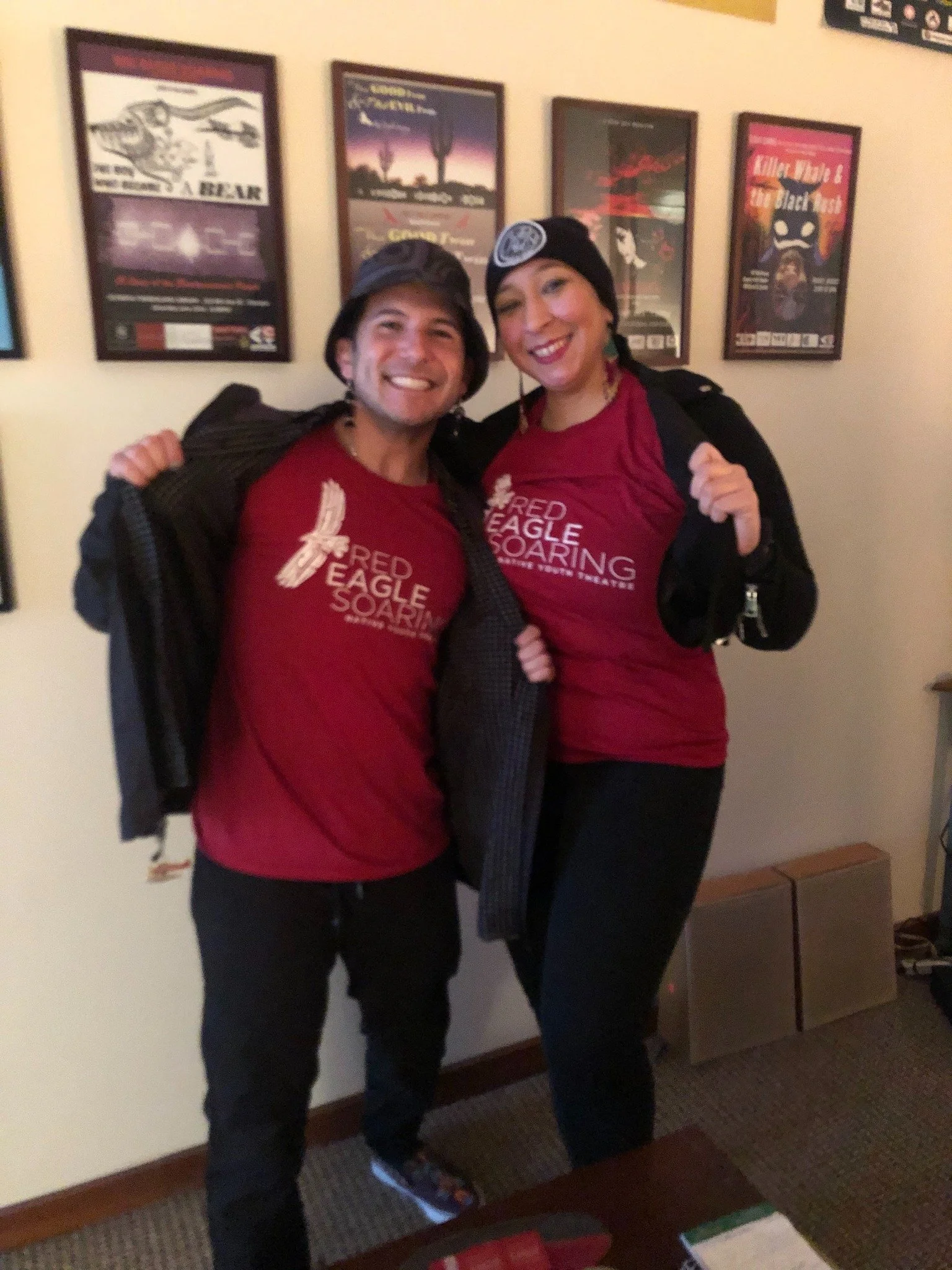 Two people wearing red shirts that say "Red Eagle Soaring".