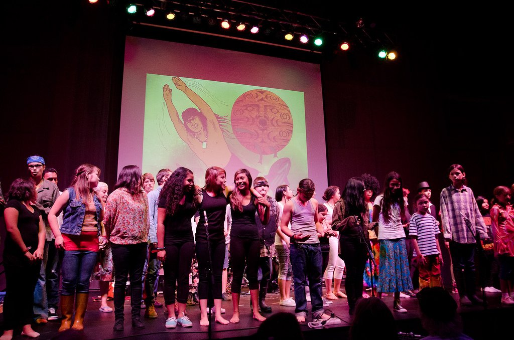 Red Eagle Soaring community members posing on stage fter a performance.