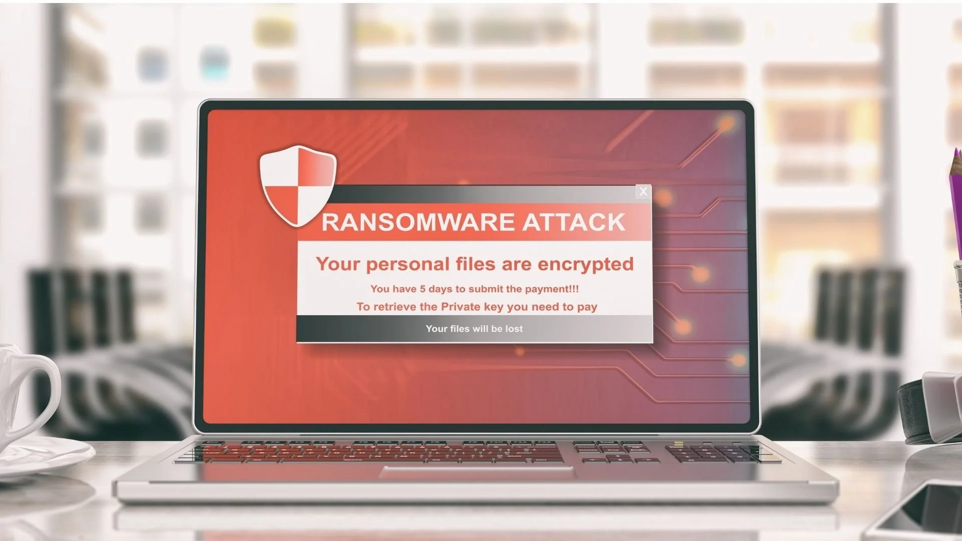 Words RANSOMWARE ATTACK on laptop screen