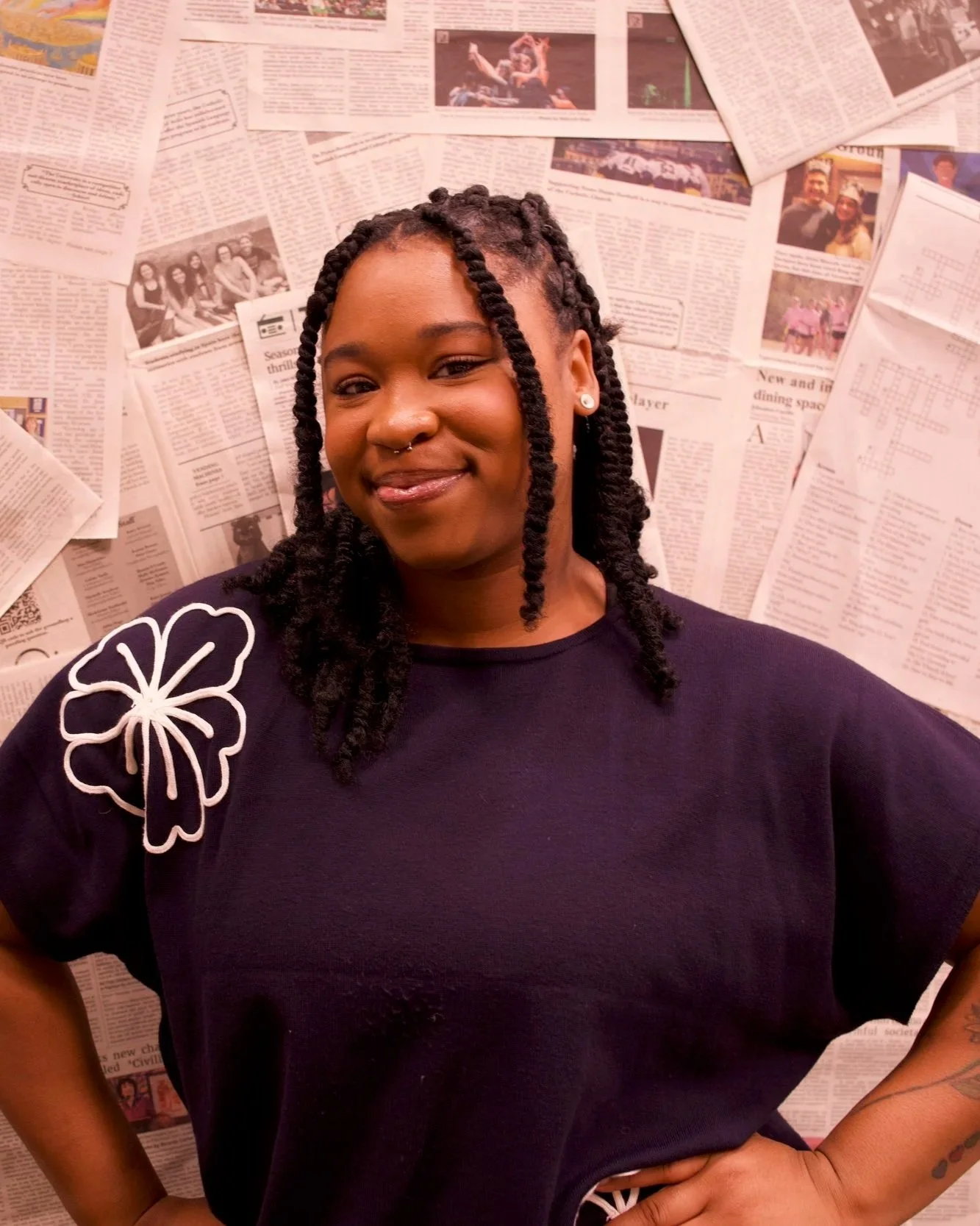 Clinician photographed during a professional portrait session in front of a newspaper backdrop.