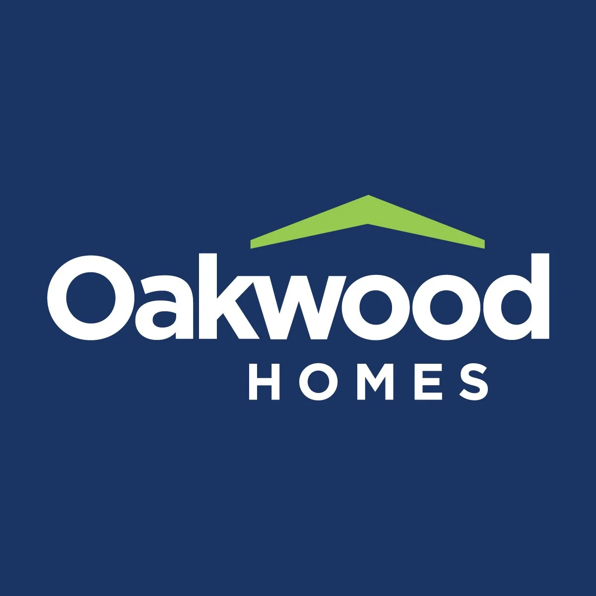Logo for Oakwood Homes with the word 'Oakwood' in large white letters and 'HOMES' underneath, featuring a green roof graphic above the text on a blue background.