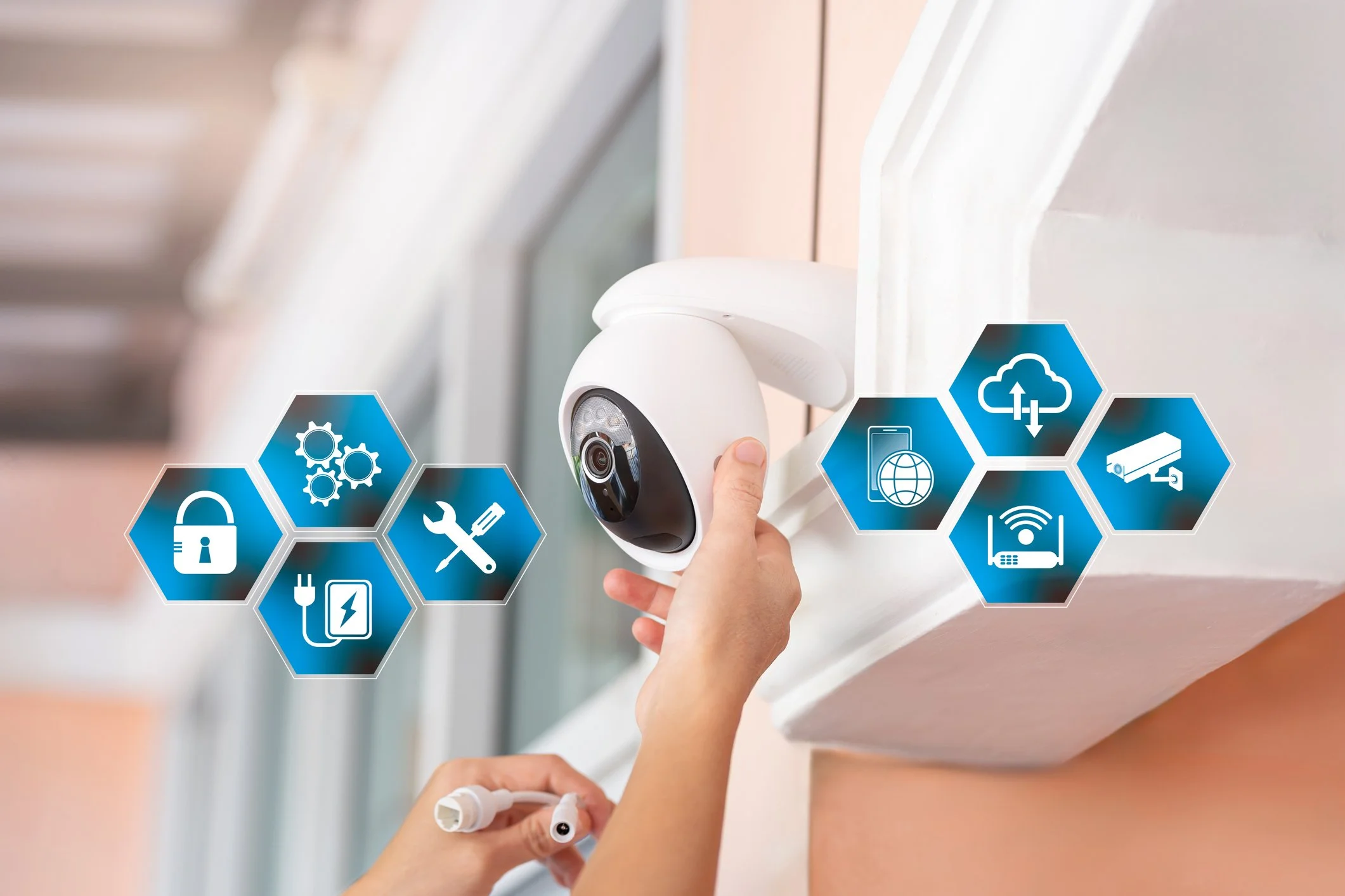 Close-up of a person installing a security camera on a wall with digital security, connectivity, and technology icons overlayed.
