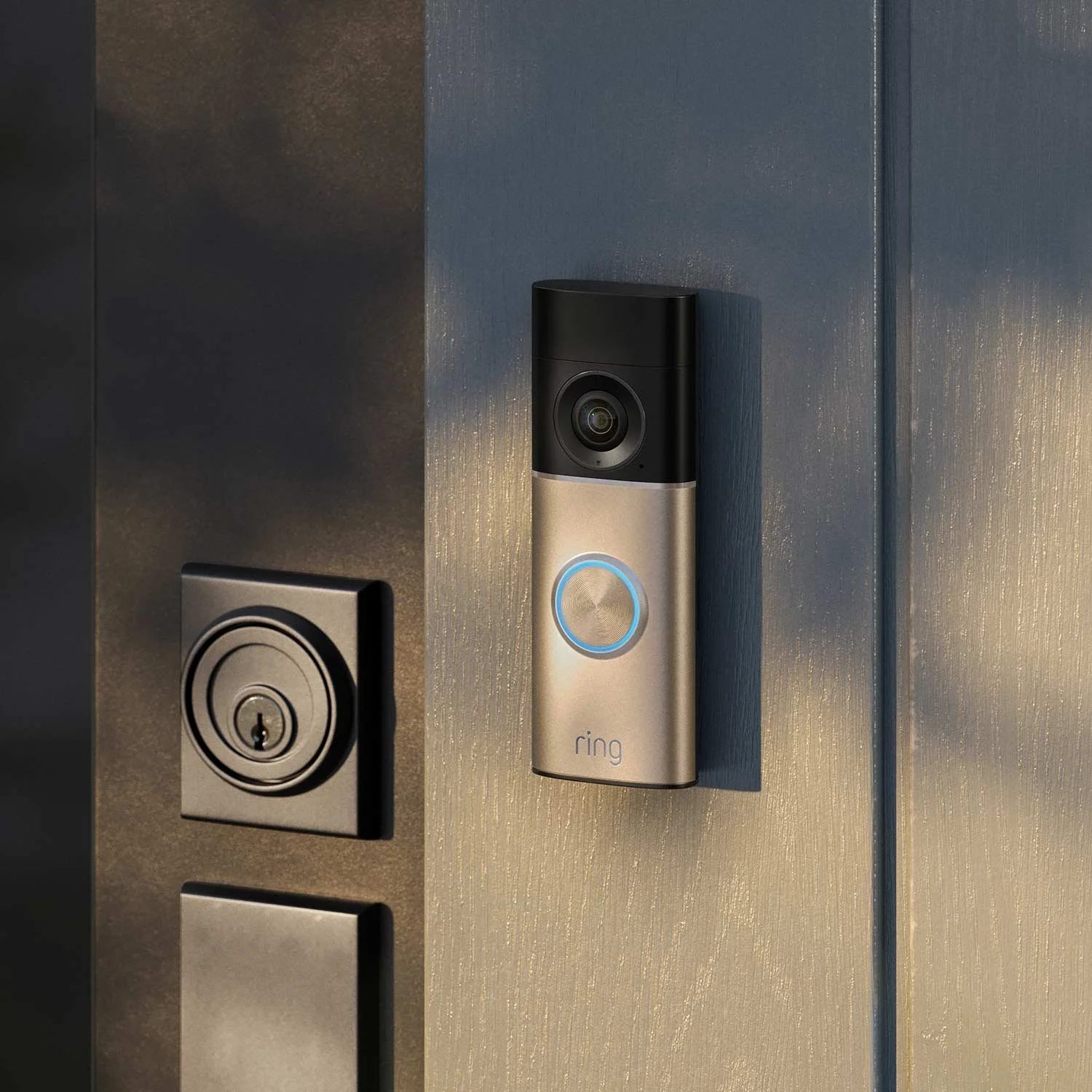 Ring video doorbell mounted on a wall near a door lock and keypad.