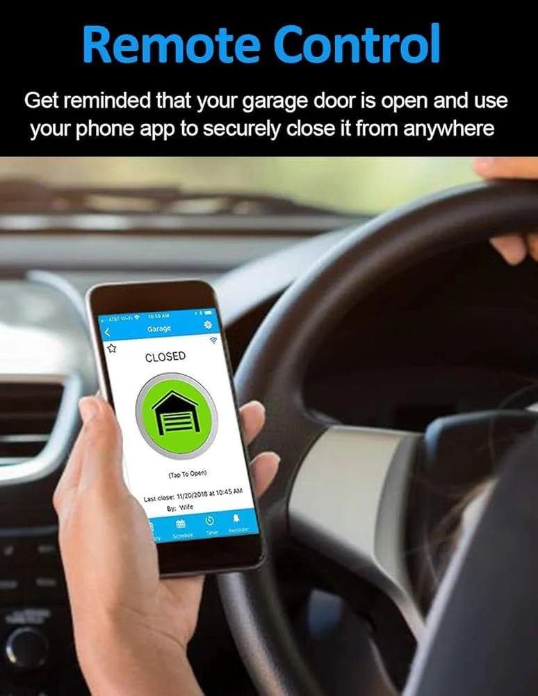 Smartphone displaying a garage door remote control app showing the garage is closed, with instructions to tap to open. The phone is held in a person's hand inside a vehicle at the steering wheel.