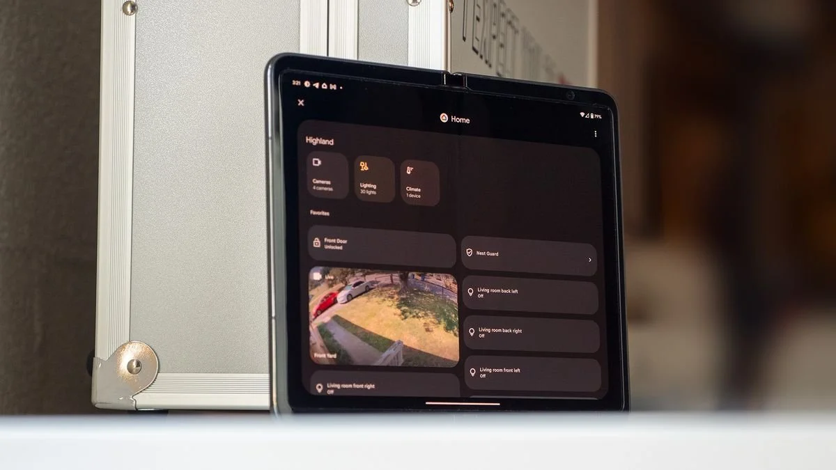 Tablet displaying a security camera app with live footage of a front porch and house yard.