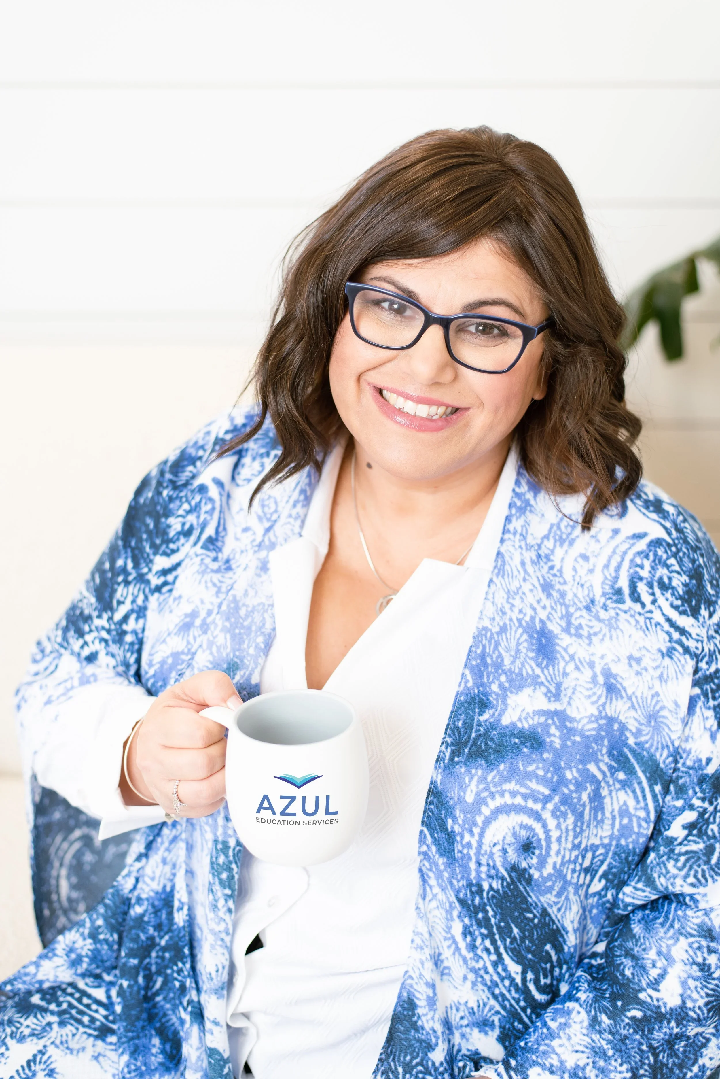 Helen smiling with Azul mug and blue patterned scarf