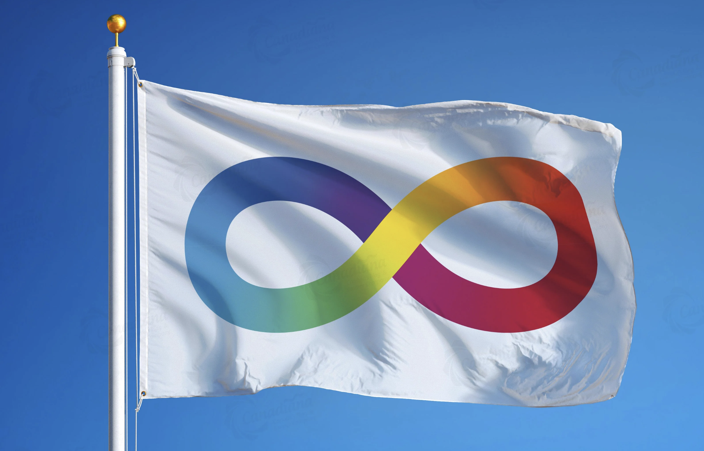 A white flag with a colorful infinity symbol on it, flying against a clear blue sky.