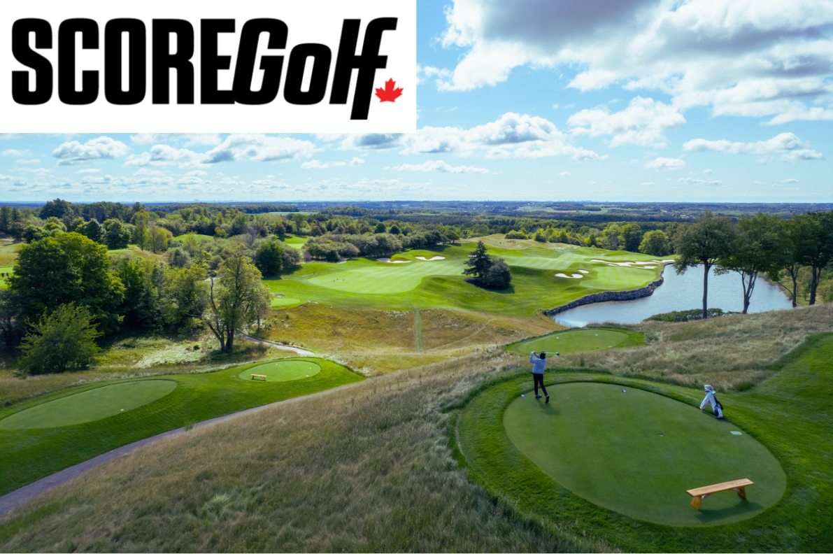 A scenic golf course with green fairways, sand traps, a water hazard, lush trees, and a player swinging a golf club, under a partly cloudy sky.