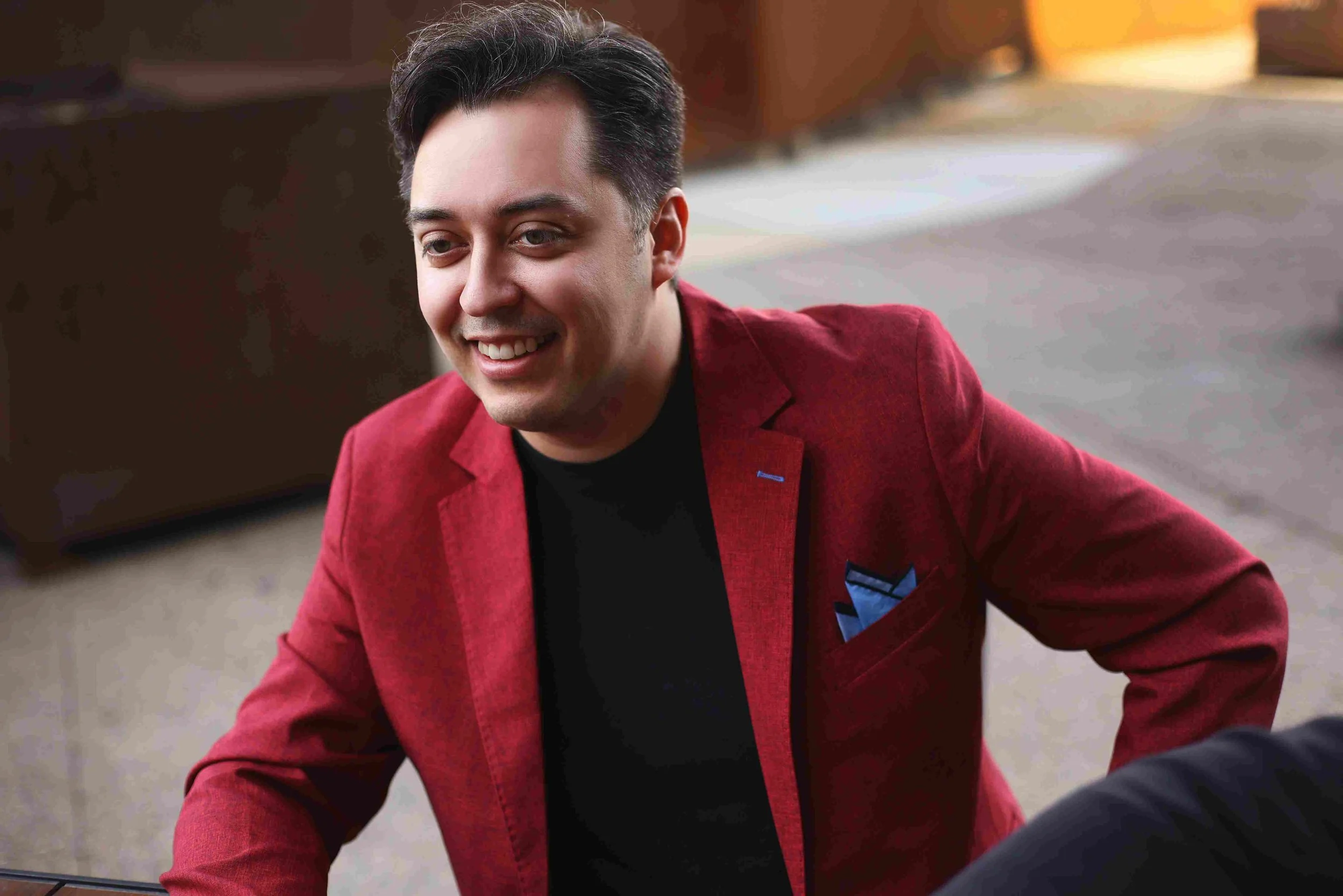 Jason in a red suit coat