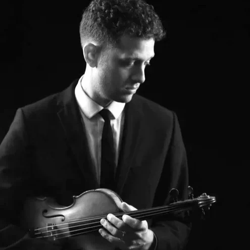 Gio holds his violin