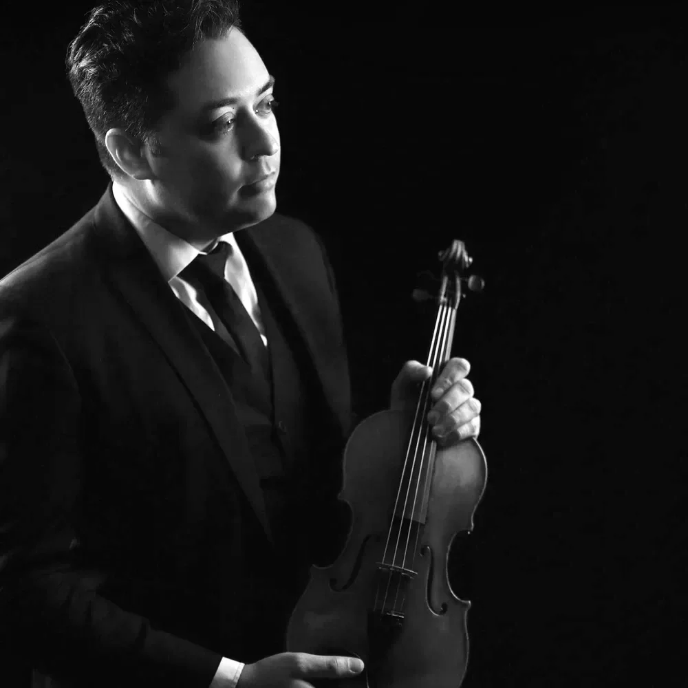 Jason holds his violin