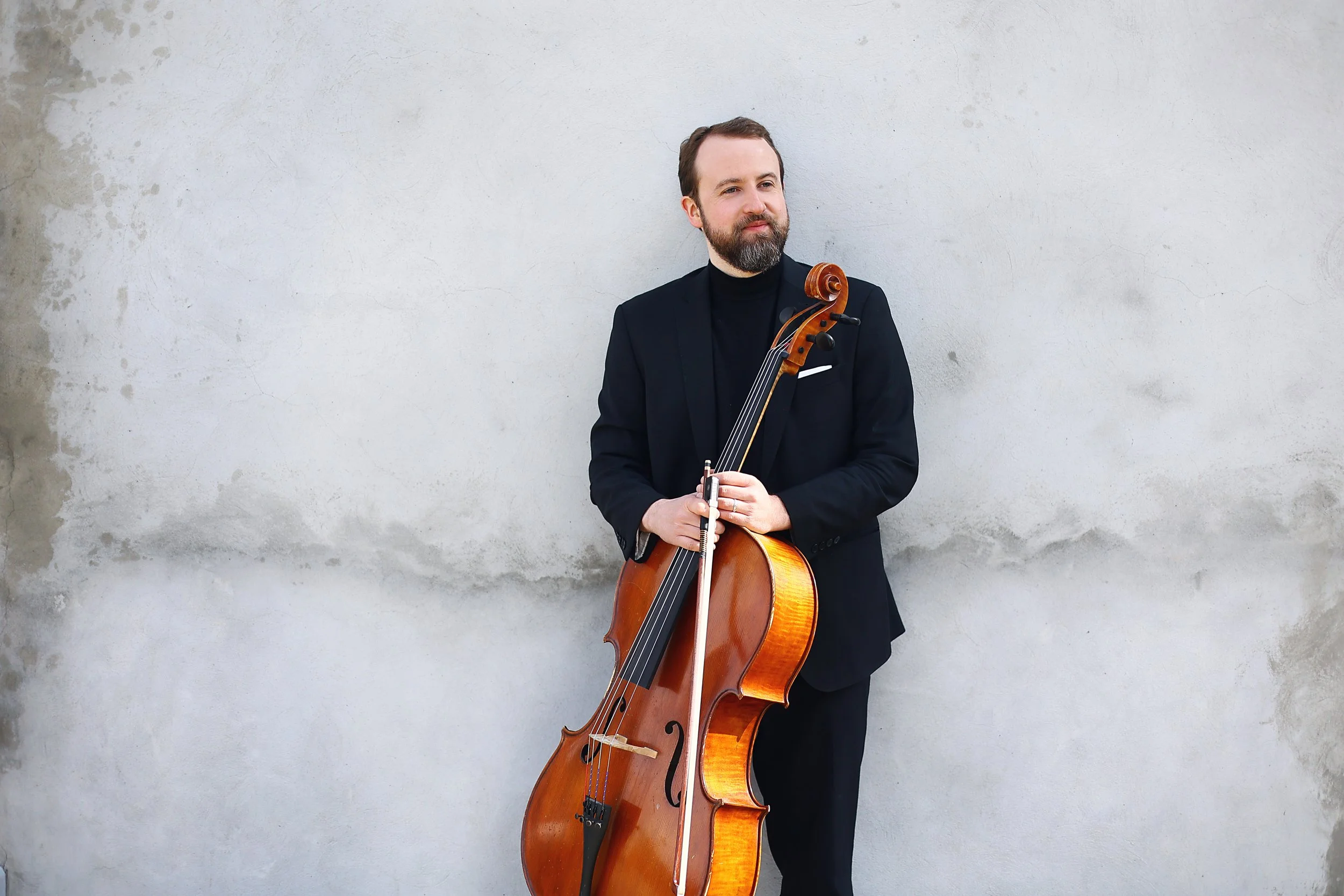 Ryan stands at the white wall