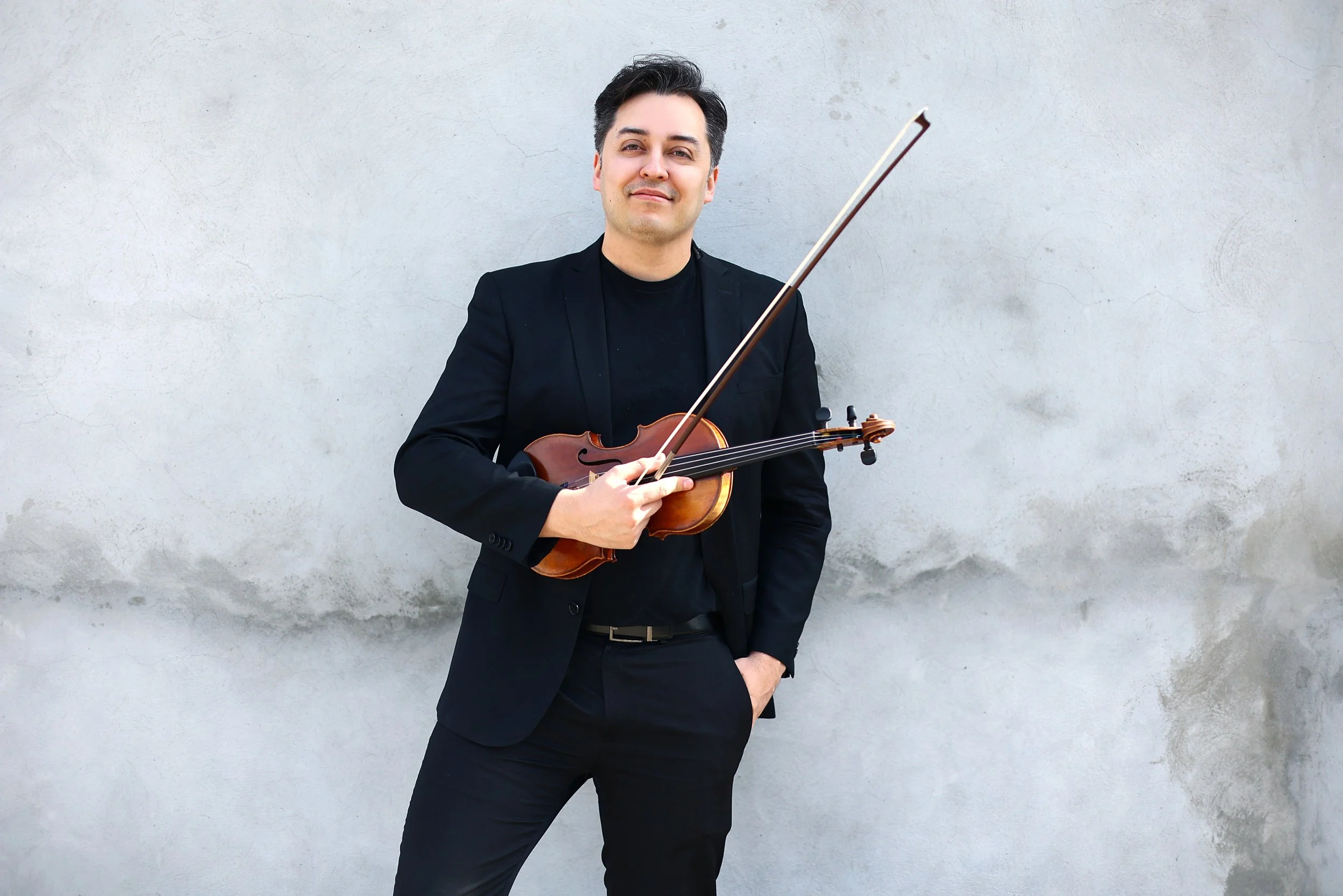 Jason stands at the white wall