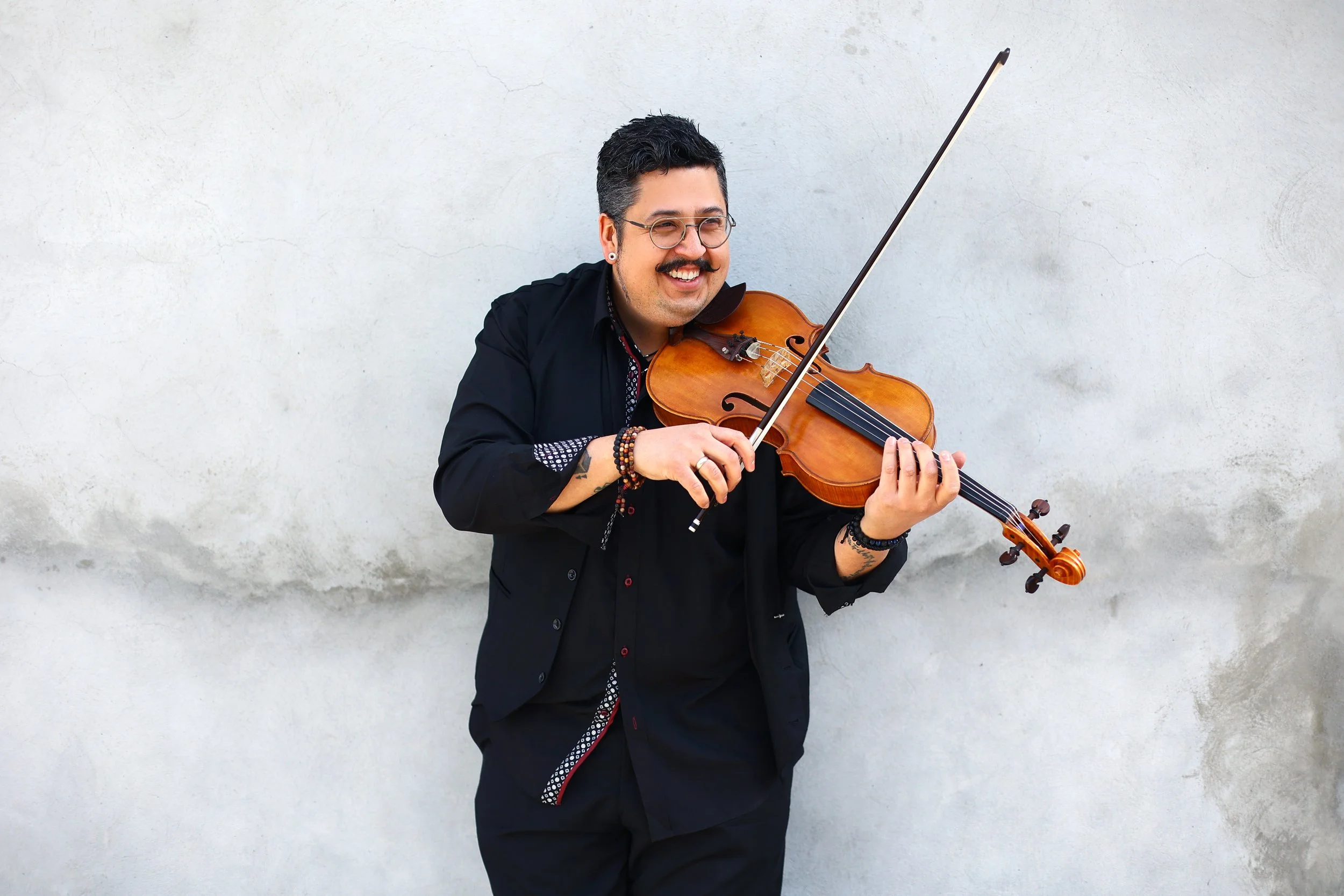 Sean stands at the white wall