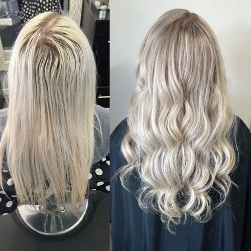 Side-by-side comparison of a woman's hair before and after salon treatment: the before shows long, straight, platinum blonde hair with visible roots, and the after shows long, wavy, platinum blonde hair with a more polished and styled look.