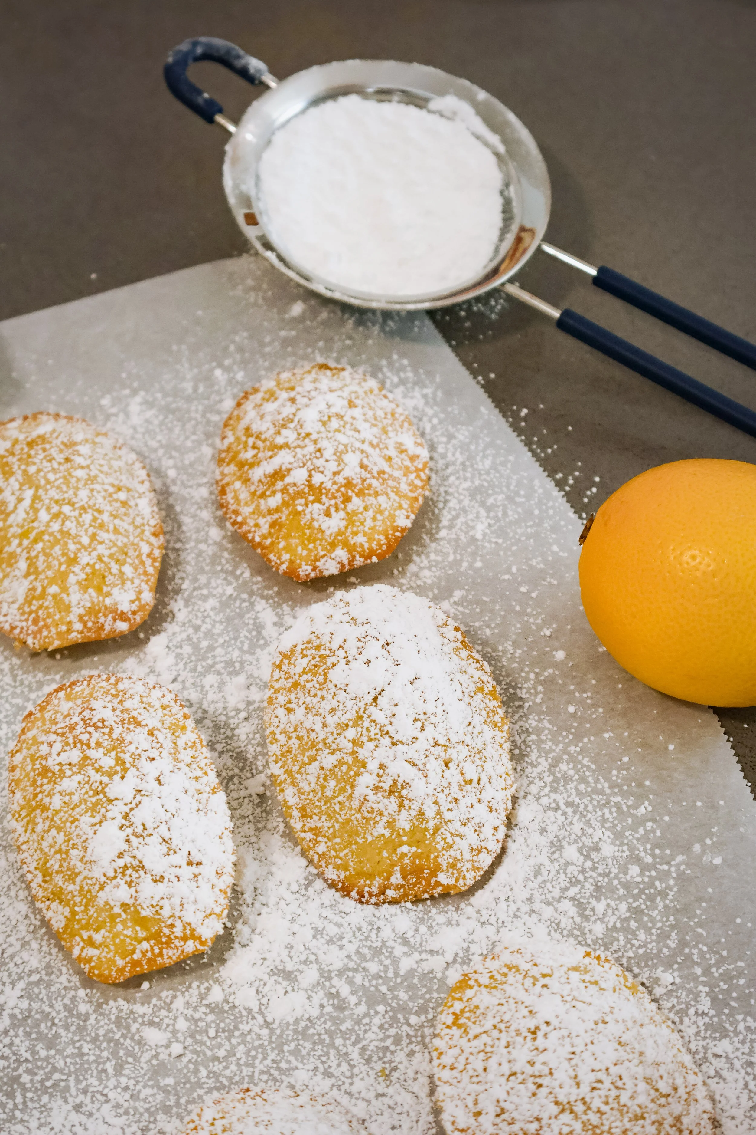 close up of lemon madeleines topped with powdered sugar