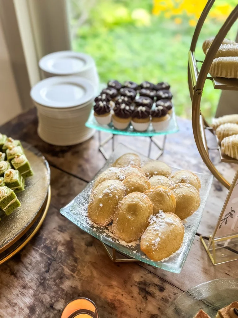 Dessert table spread with gluten-free cookies, cupcakes and madeleines