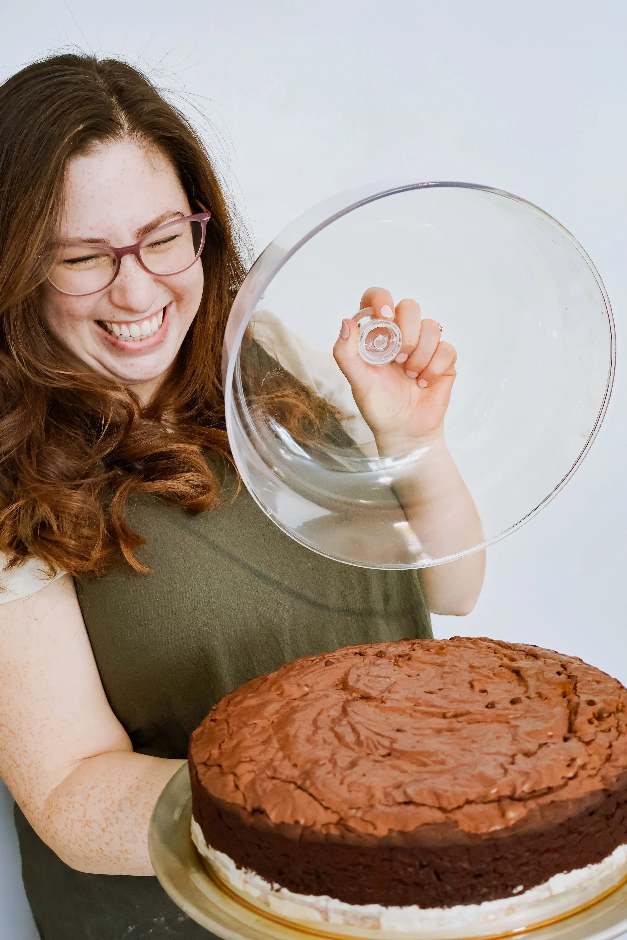 Undecorated large gluten and dairy free round brownie cake without icing placed on yet