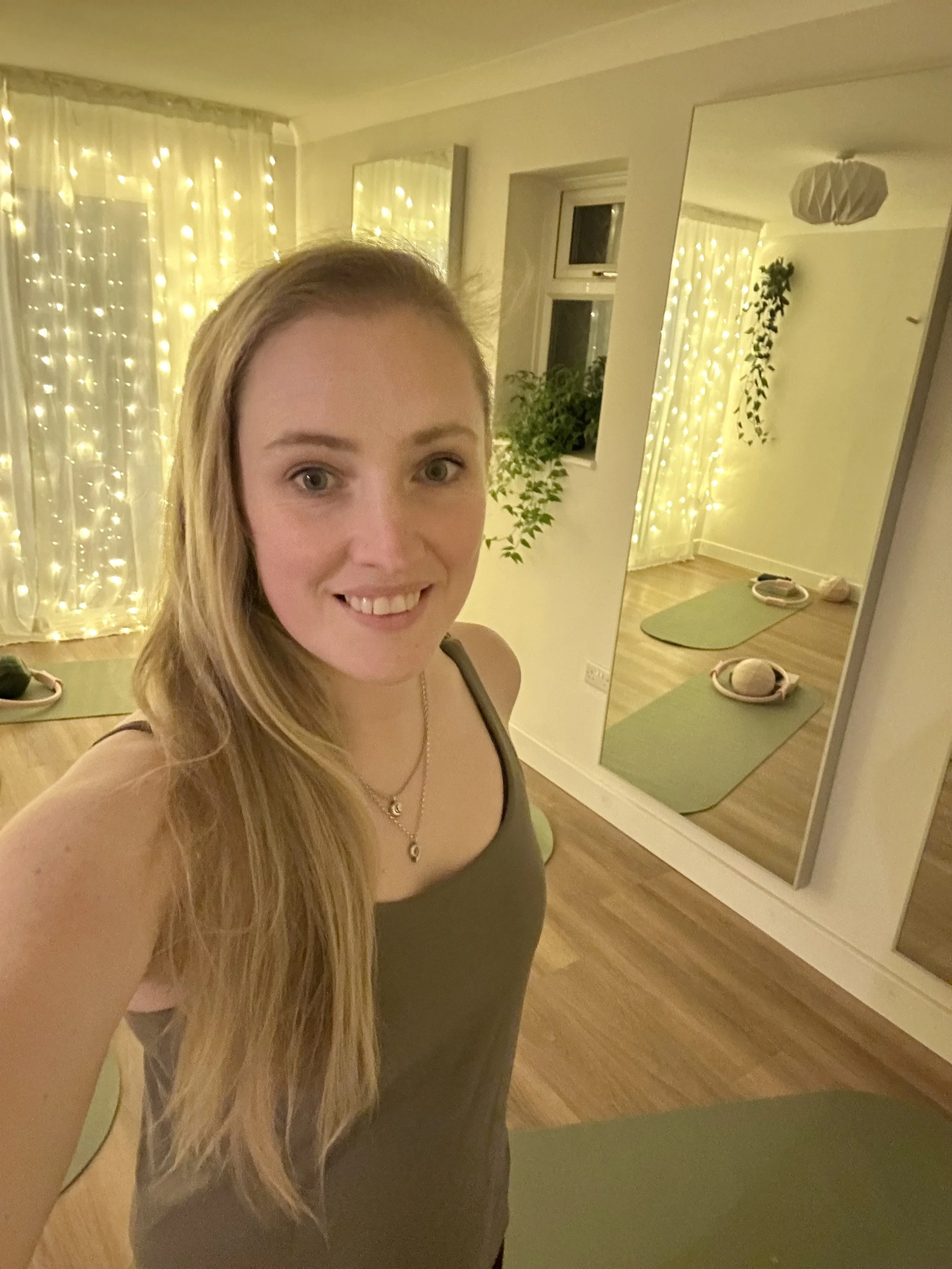 Pilates teacher standing in purpose built pilates studio to teach small beginner classes