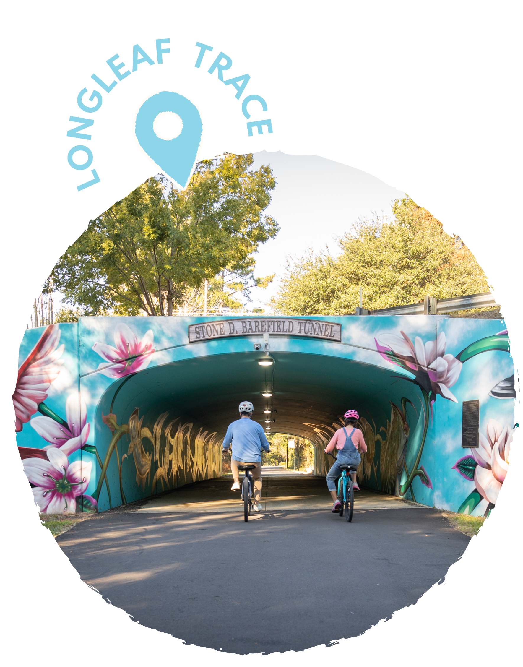 Two children riding bicycles through the Stone D. Barefield Tunnel decorated with colorful floral murals and mural art surrounding the entrance.
