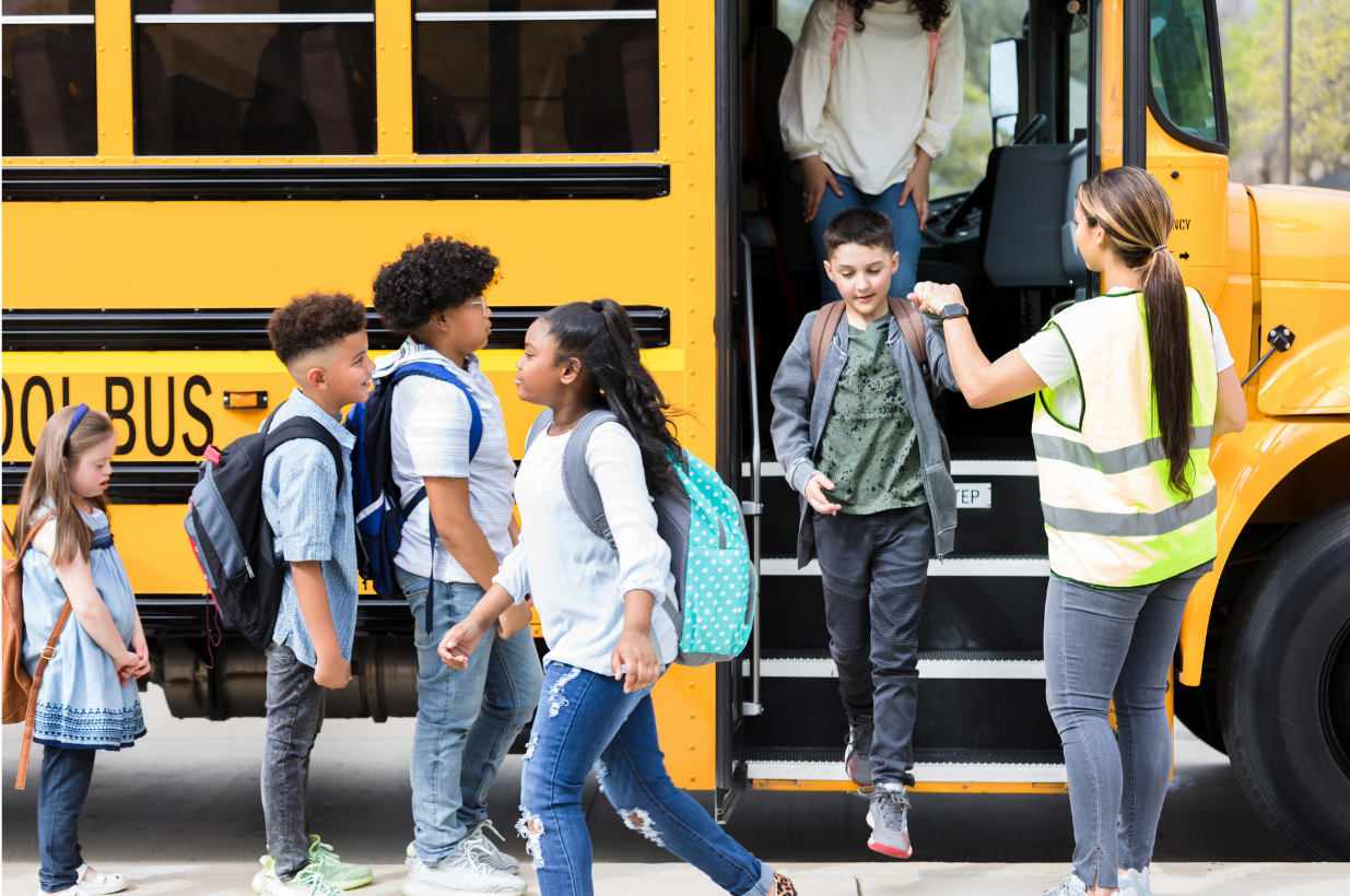 Greg Holmes standing in front of an illuminated Cisco sign on a textured dark wall.