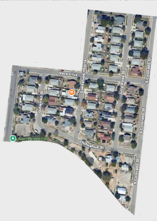 Satellite view of a neighborhood with streets named Vera Cruz, Guadalupe Ybarra, Julia Ross Street, S. Colorado Street, and Chihuahua Street. The neighborhood has houses, trees, and a trail called Apache Creek Trail.