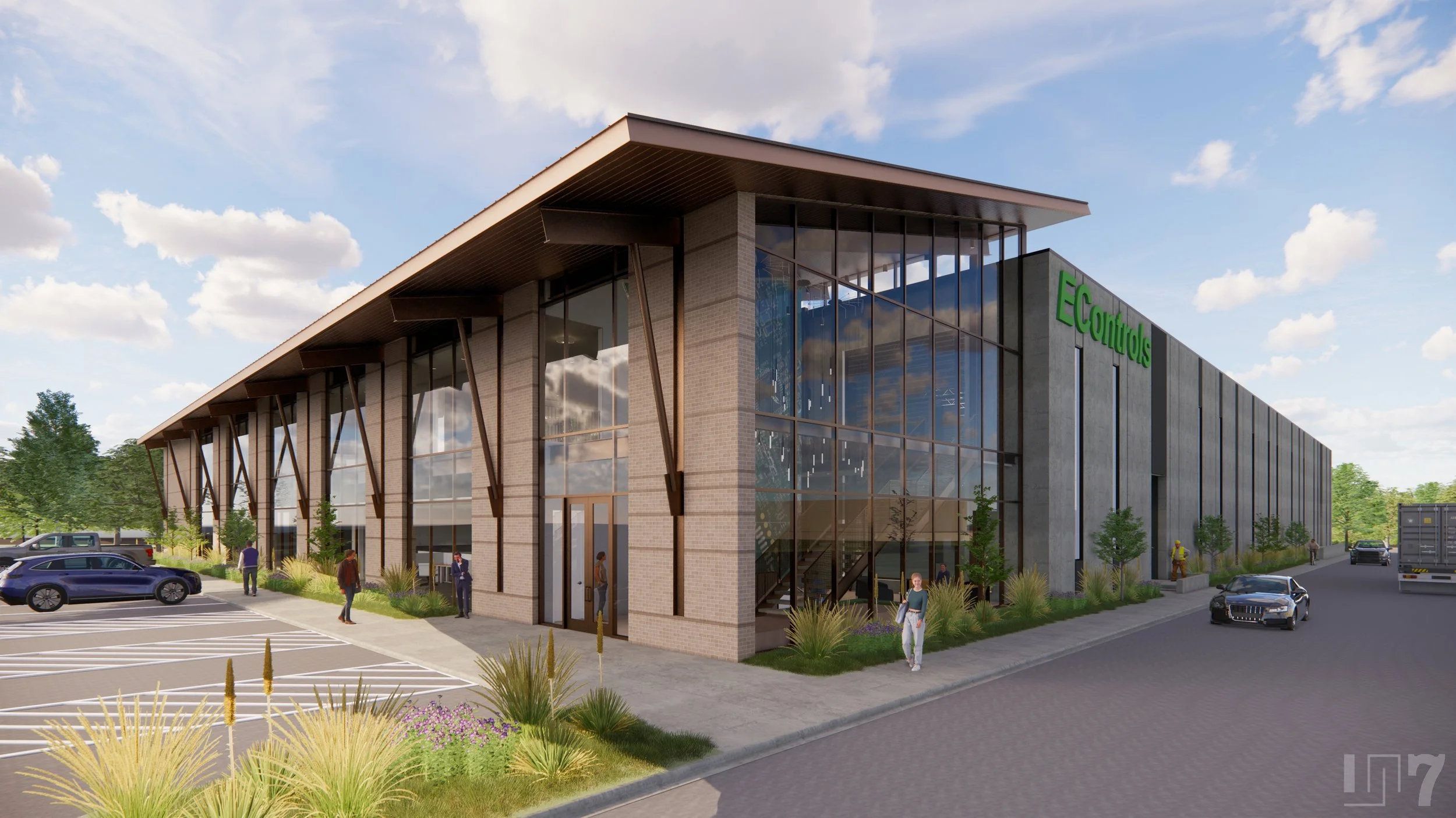 Modern commercial building with large glass windows, surrounded by parking lot and landscaped greenery, with a sign that reads 'EControls' on the side.