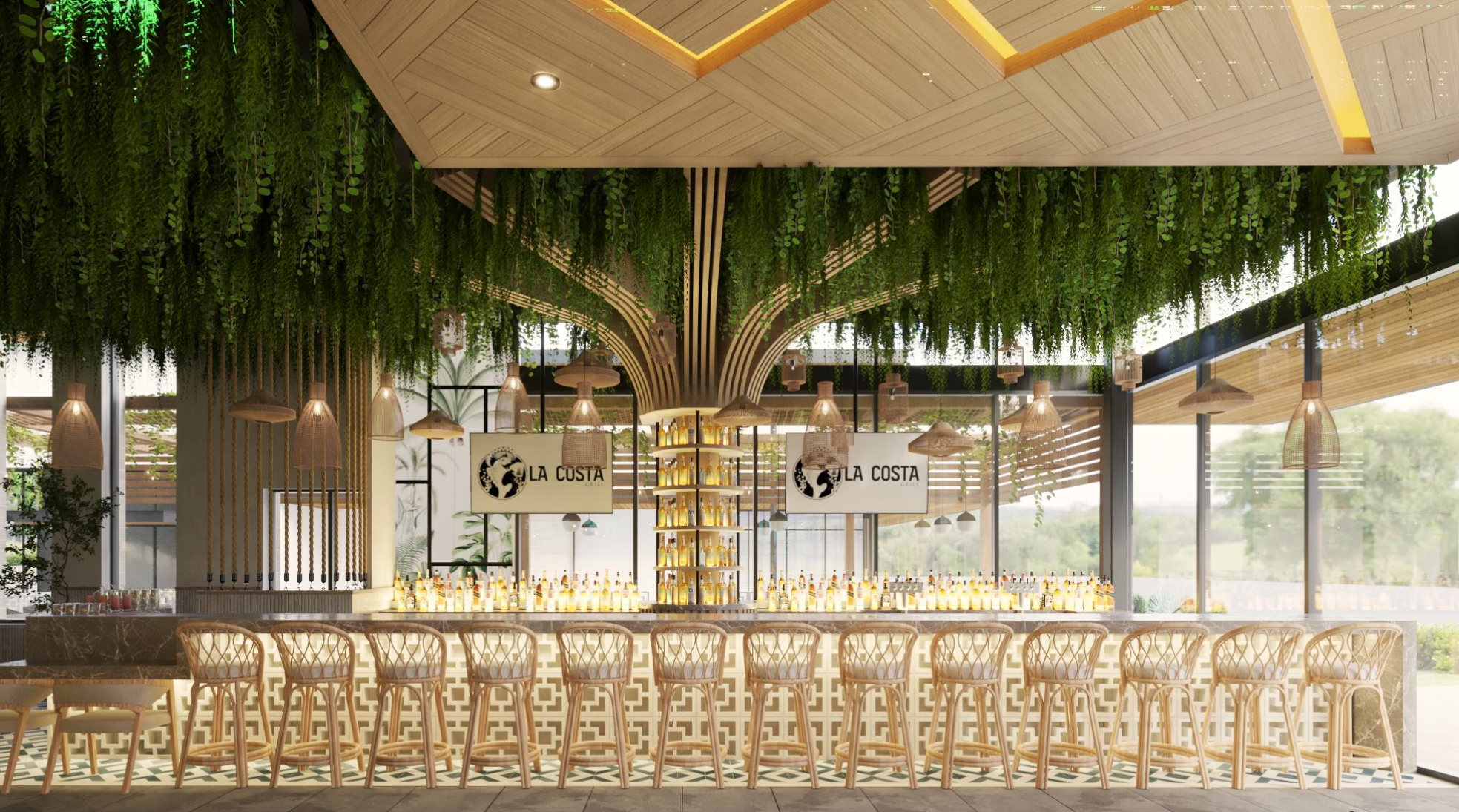 Modern bar interior with hanging greenery on the ceiling, wooden accents, and a marble bar counter with bottles of alcohol. Two screens display the restaurant name, La Costa.