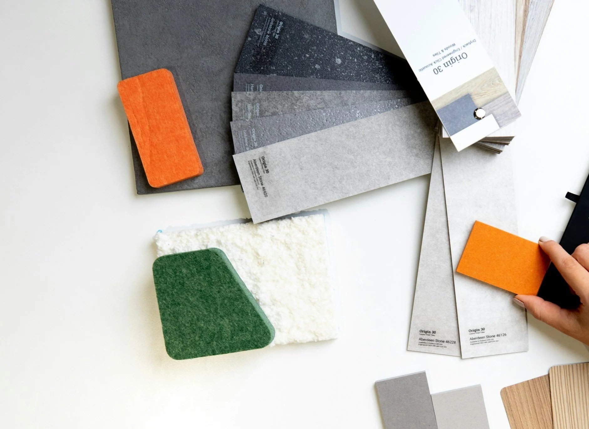 Sample color swatches and fabric or material samples arranged on a white surface.