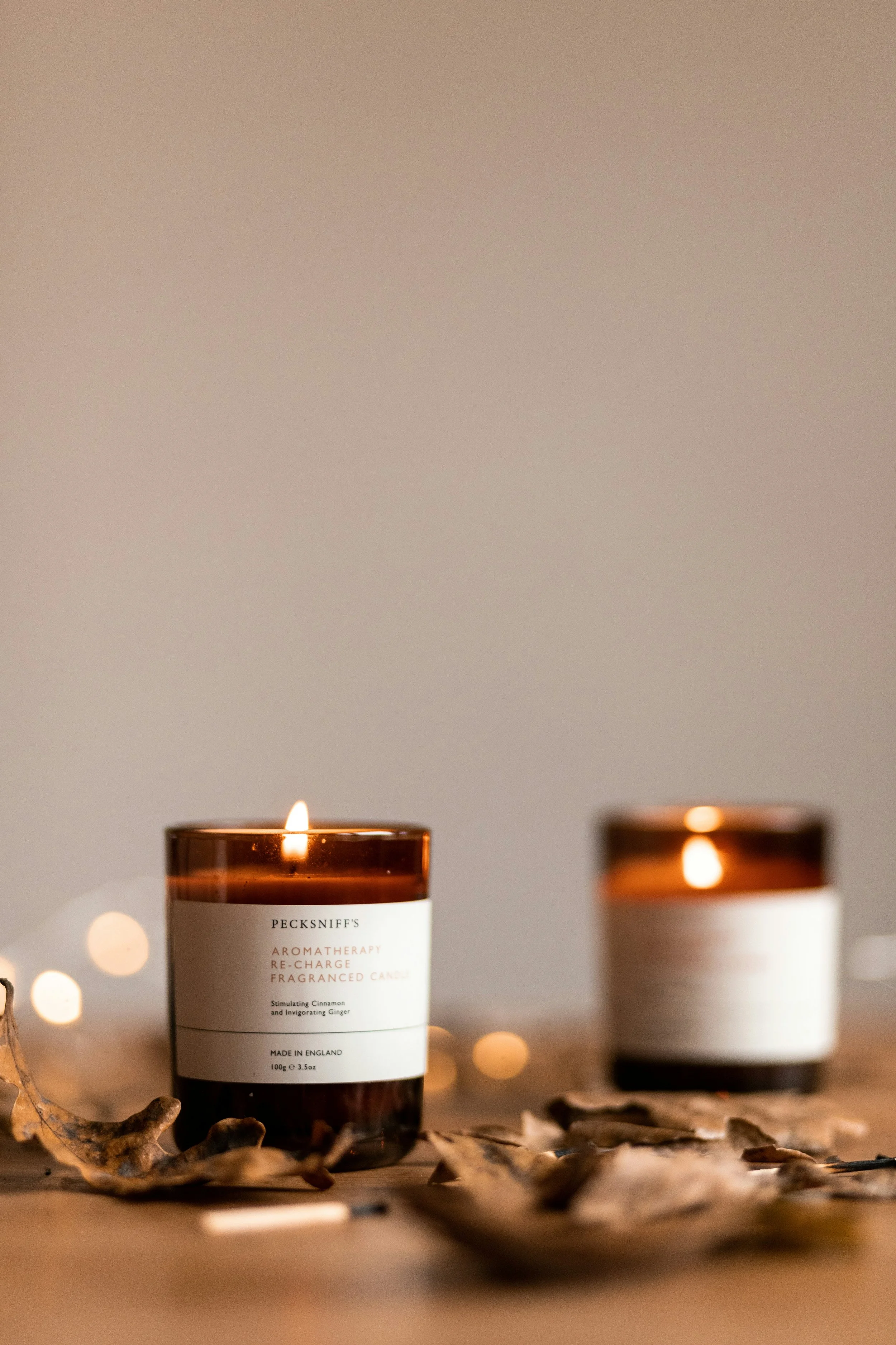 Lit brown candle creating warm ambience in a thoughtfully designed therapy office space.