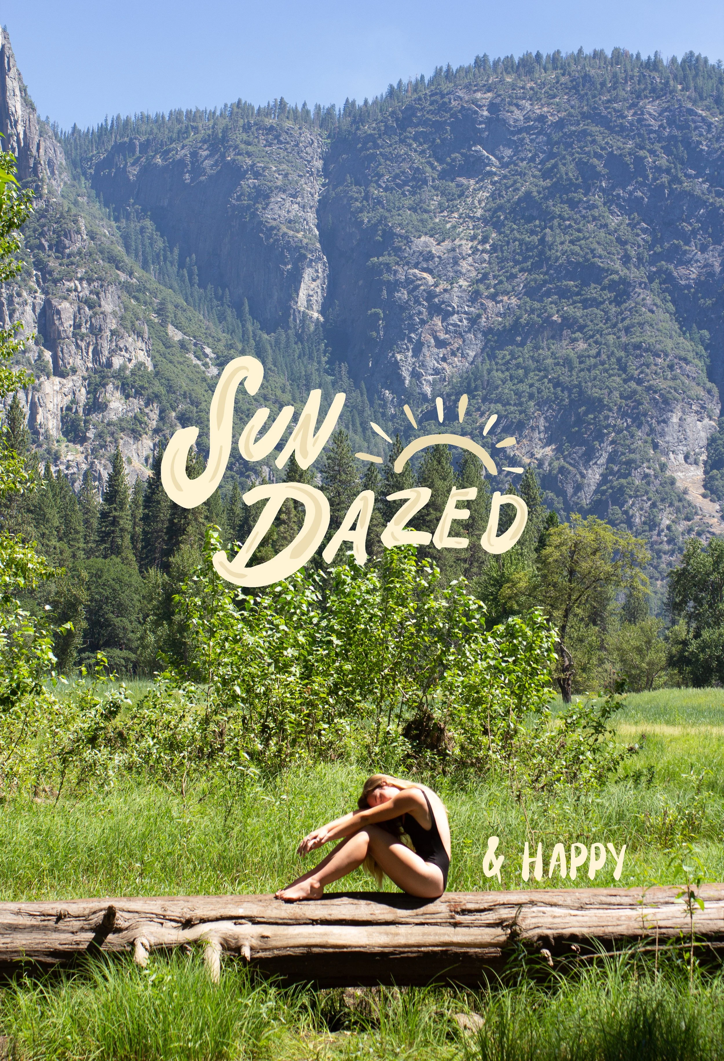 A woman sitting on a fallen log in a lush green mountain landscape, with trees and rugged mountain cliffs in the background. The image has the text 'Sun Dazed & Happy' overlaid, with a small sun illustration.