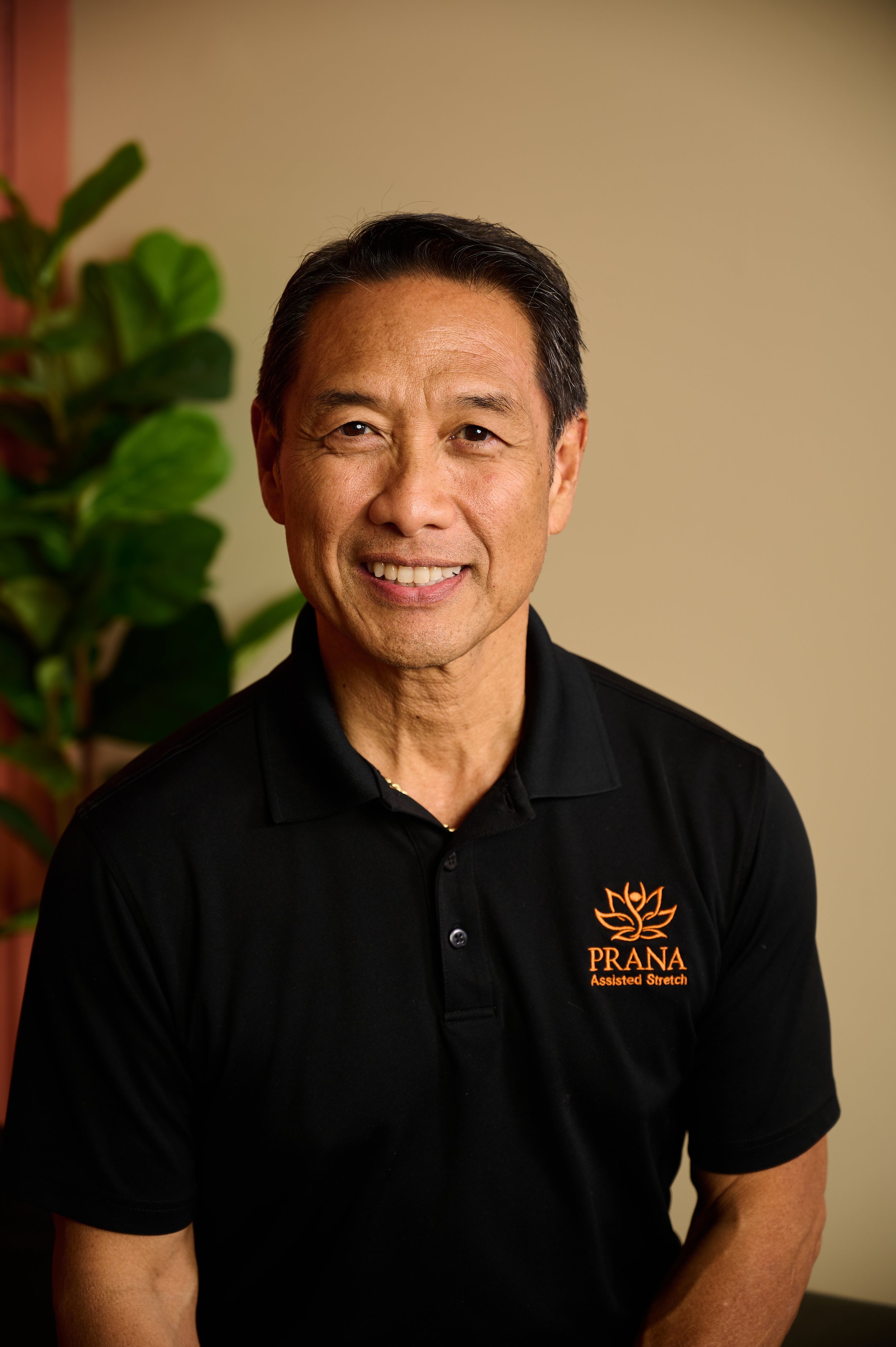 Lee Rooney, the owner of Prana Yoga & Fitness in Lynchburg VA,  wearing a black polo shirt