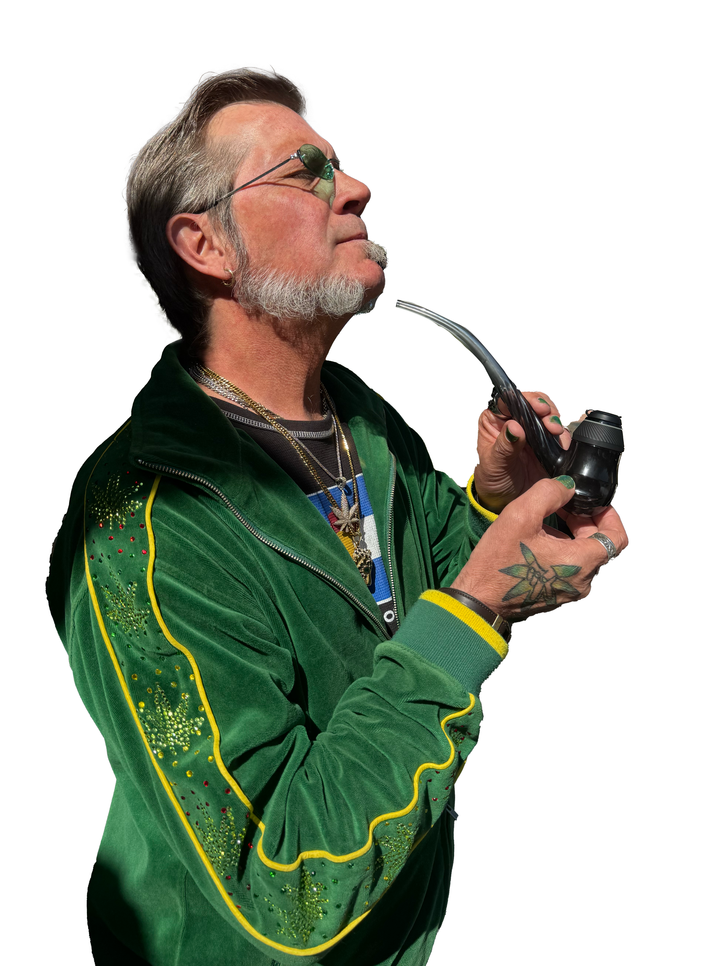 A man with glasses and a beard smoking a pipe, wearing a green jacket with yellow trim and decorative green stitching.