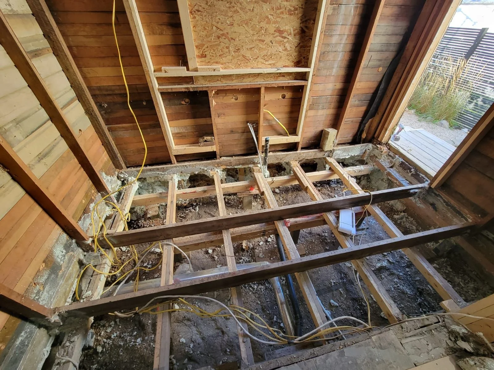 Three layers of rotted floor joists