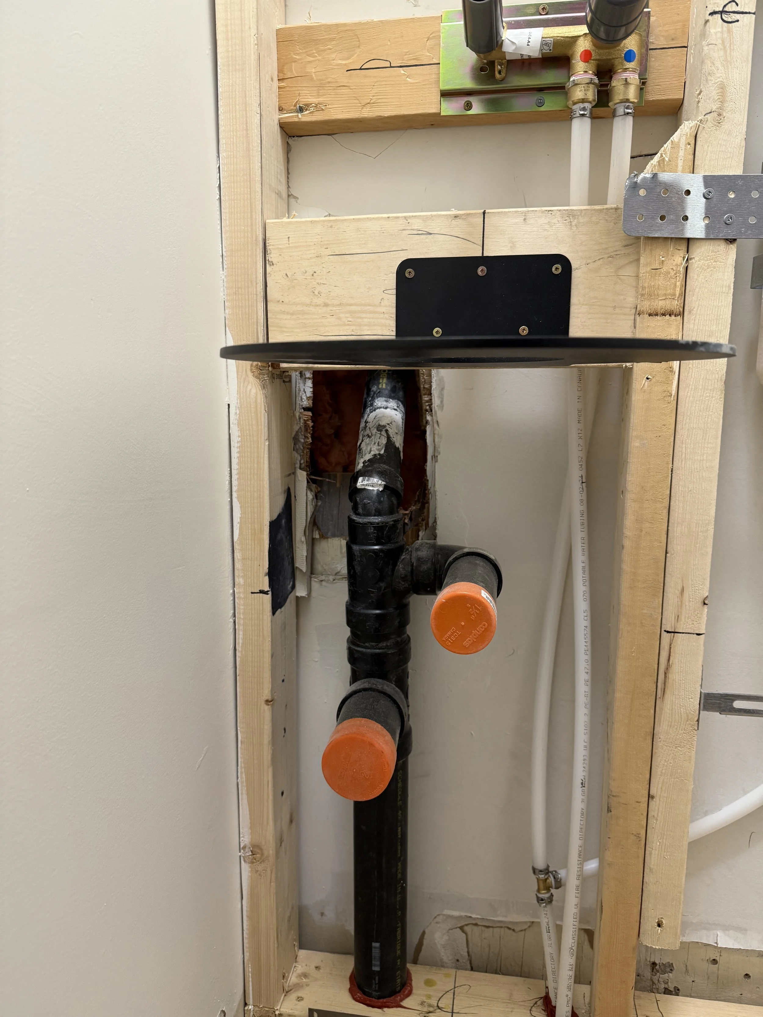 The plumbers roughed-in the sink and installed the sink support