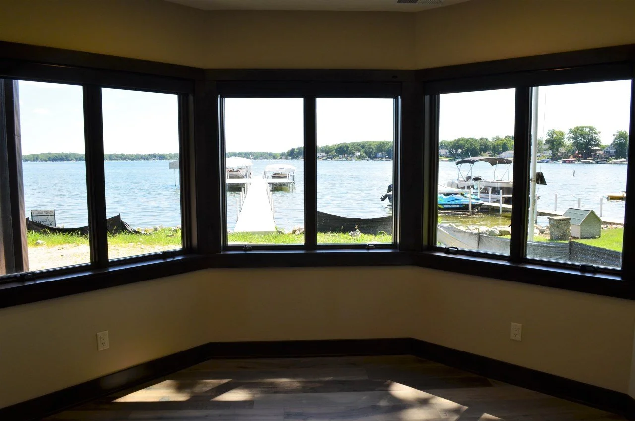 View of a lake with boat docks and boats seen through large corner window