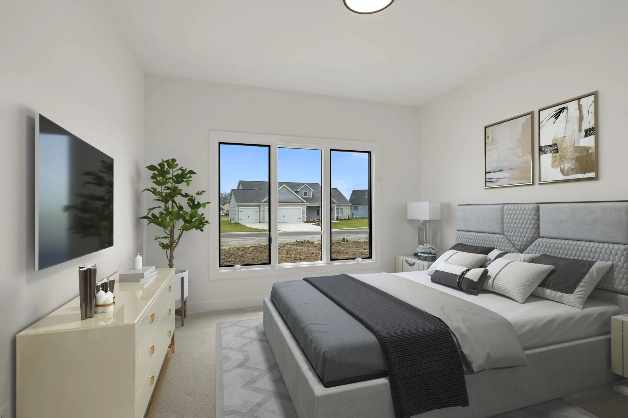 Modern bedroom with large window, white walls, bed with gray headboard, gray bedding, black throw blanket, nightstand with lamp, artwork above bed, dresser, and potted plant.