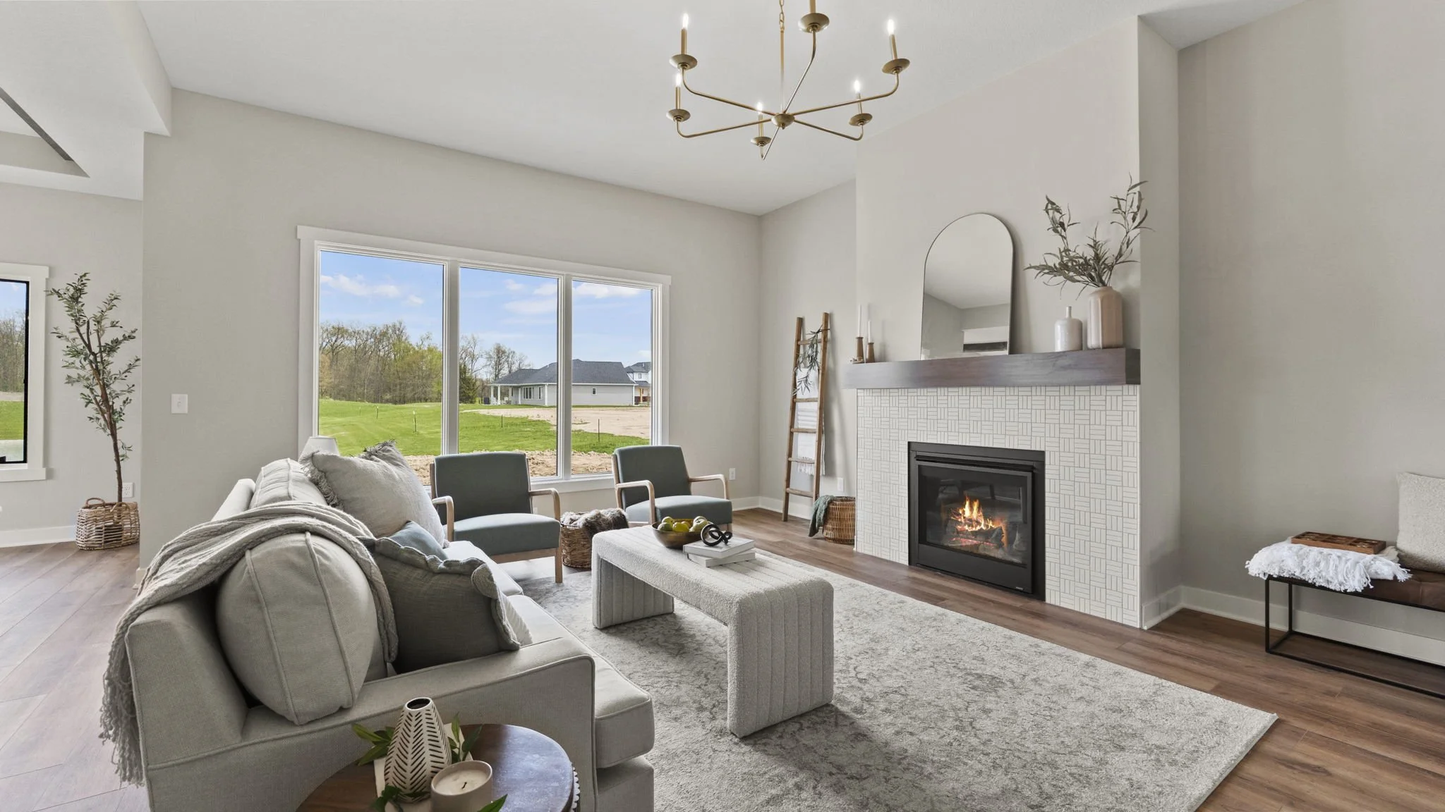 Modern living room with large windows, a fireplace, and minimalistic decor.