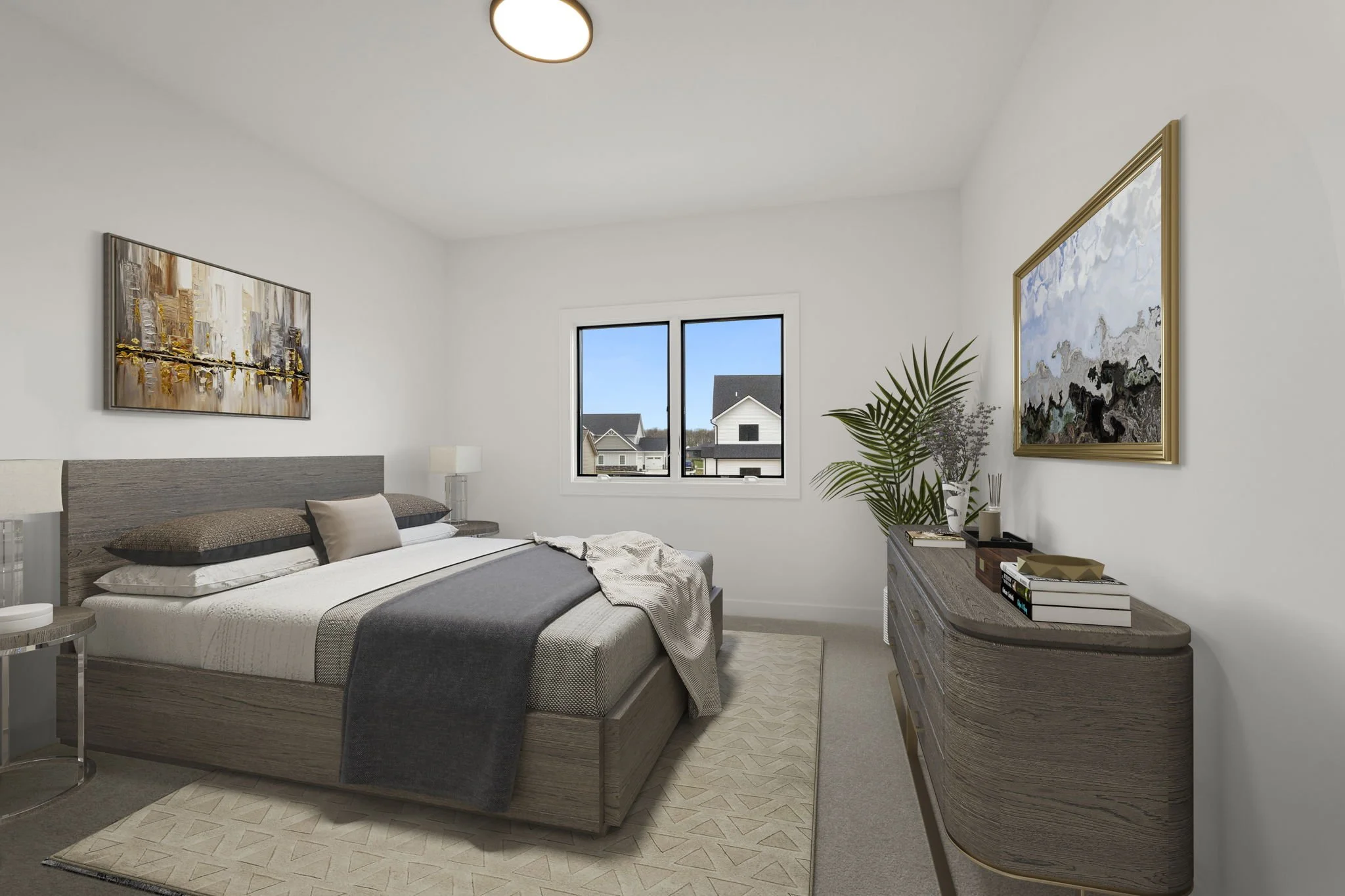 A modern bedroom with a large bed, bedside tables, and a wooden dresser. The room has white walls, a window showing neighboring houses, and artwork on the walls. There are plants on the dresser and a beige rug on the floor.