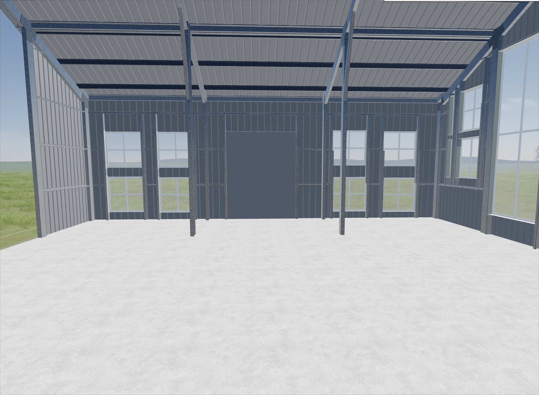 Interior view of a building under construction with metal framing and large windows, no walls or doors installed yet.