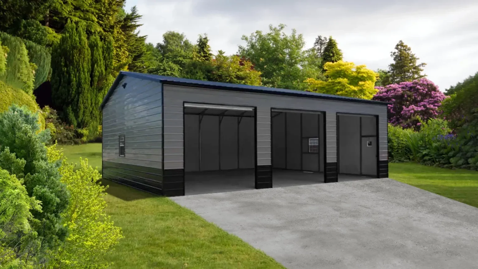 A modern metal garage with three large bays, situated on a concrete driveway in a lush garden setting with green trees, shrubs, and flowering plants.
