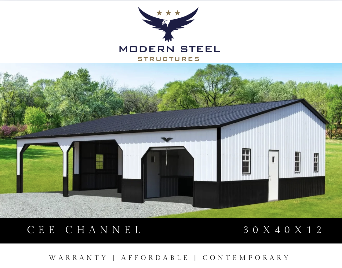 Photo of a modern metal barn with white and black siding, multiple windows, a side door, and a covered area, set on a grassy field with trees in the background.