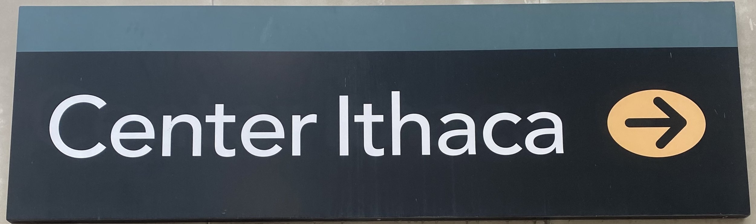 Sign pointing to Center Ithaca with a right arrow symbol.