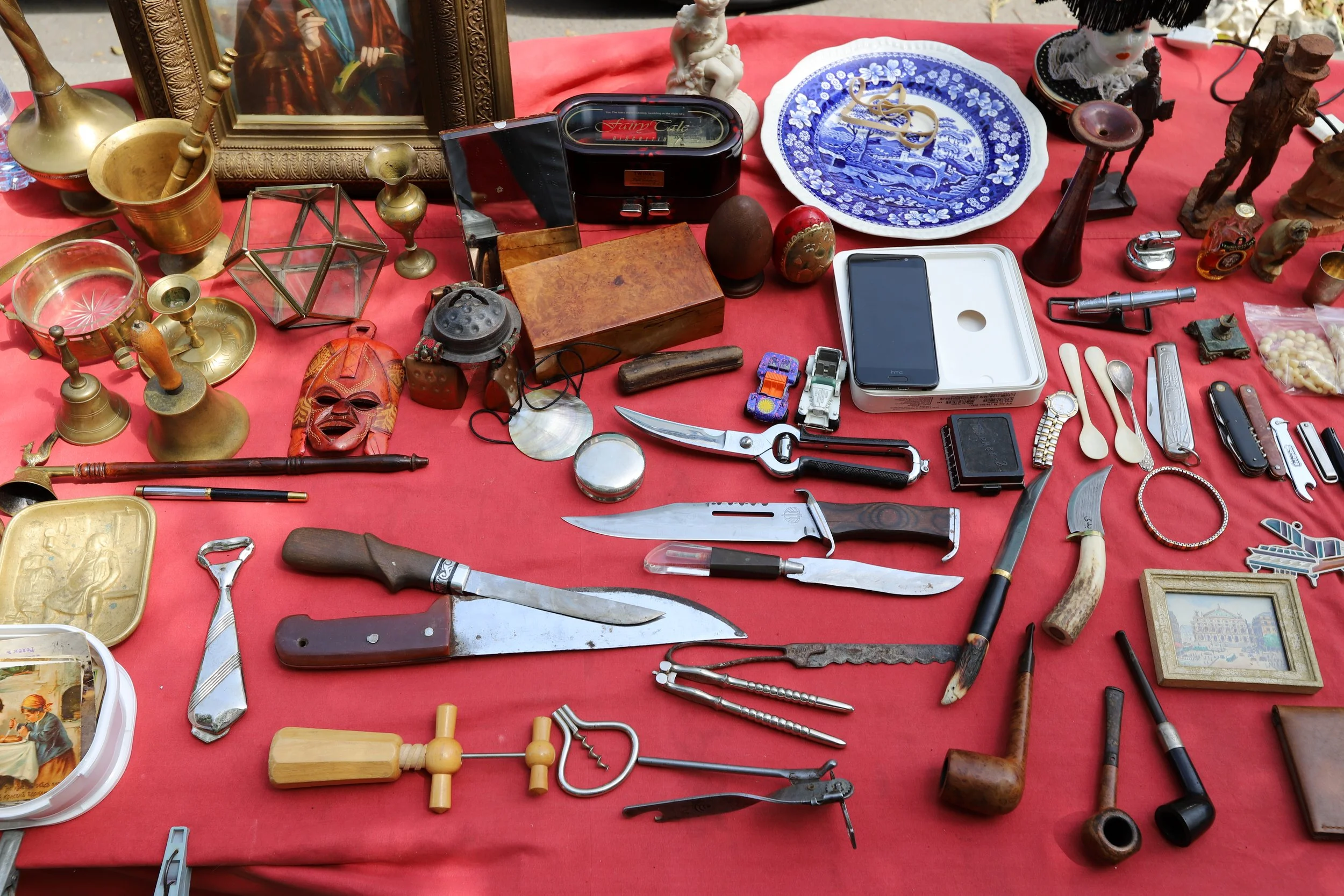 Table with eclectic items layed out on it for sale