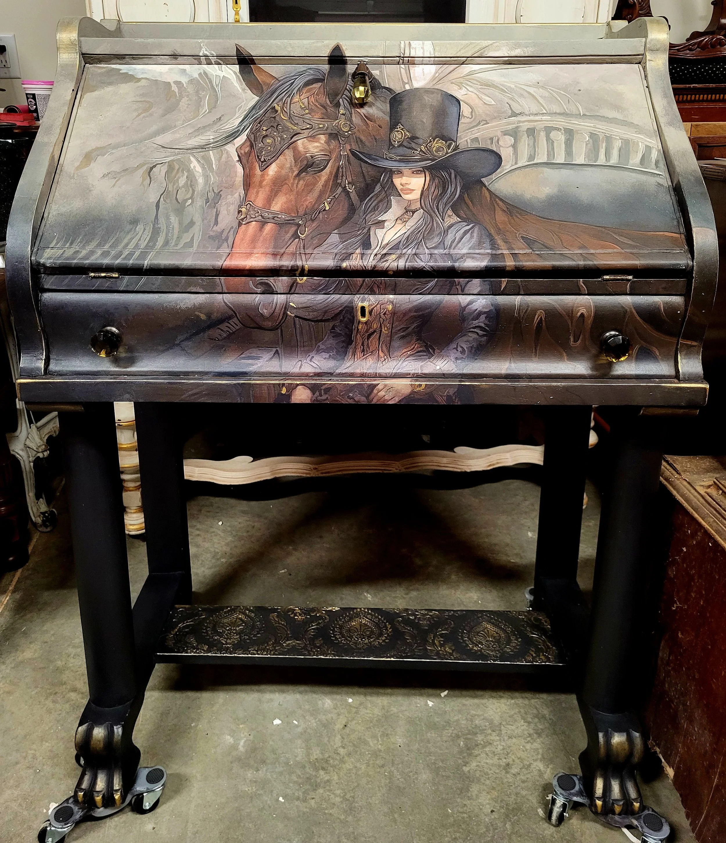A vintage-style writing desk with a painted illustration of a woman in a steampunk outfit and a horse on the front panel.