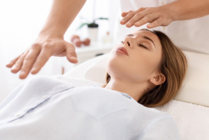 Person receiving a gentle head massage in a spa or wellness setting