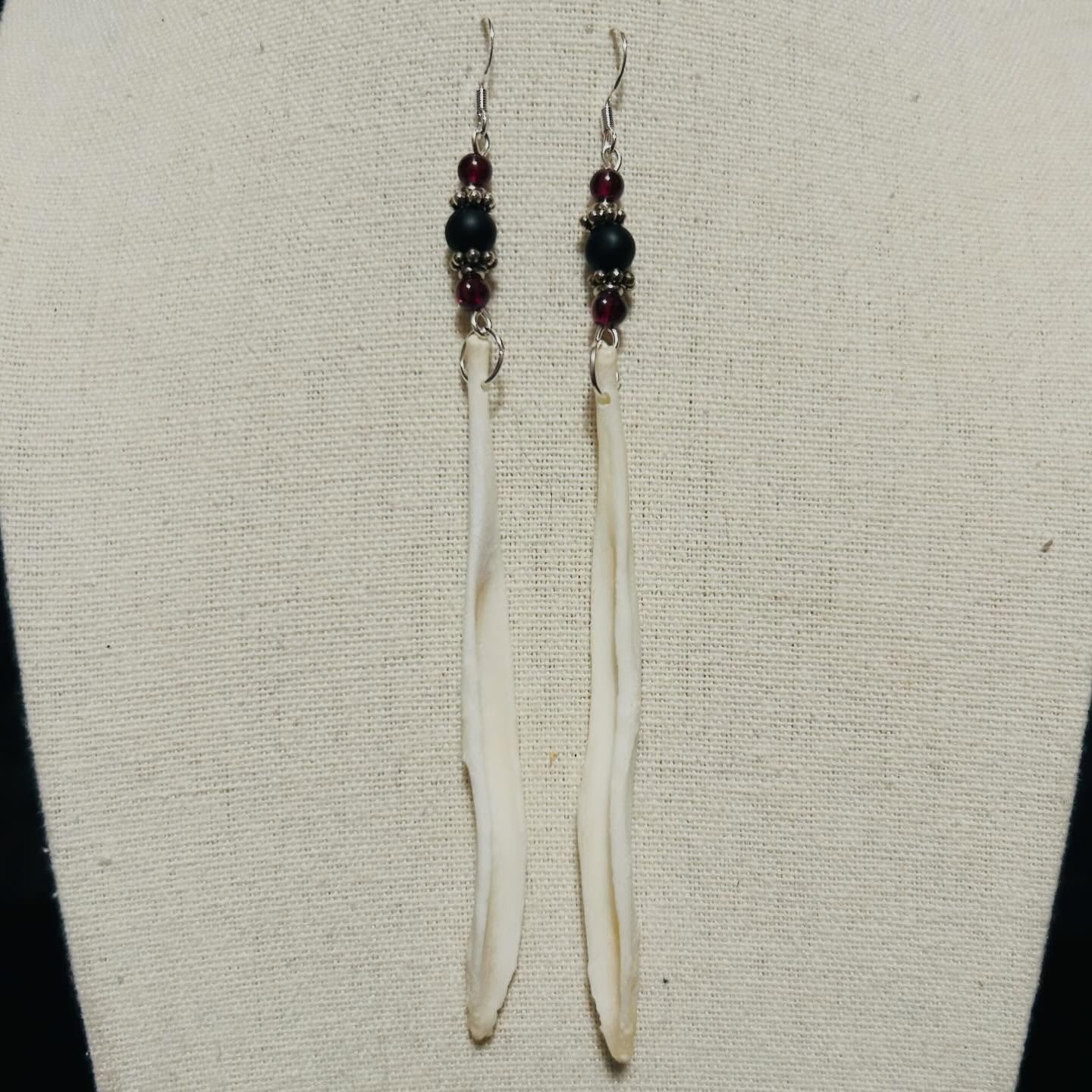 Coyote baculum with garnet and matte black, glass beads.